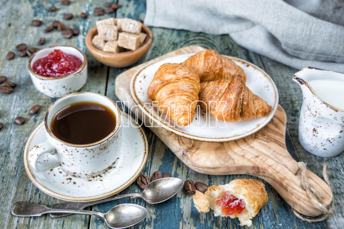 Lifestyle – Per tenersi in forma serve una sana colazione - Light breakfast consisting of a cup of black coffee and croissants with a stuffing from raspberry jam